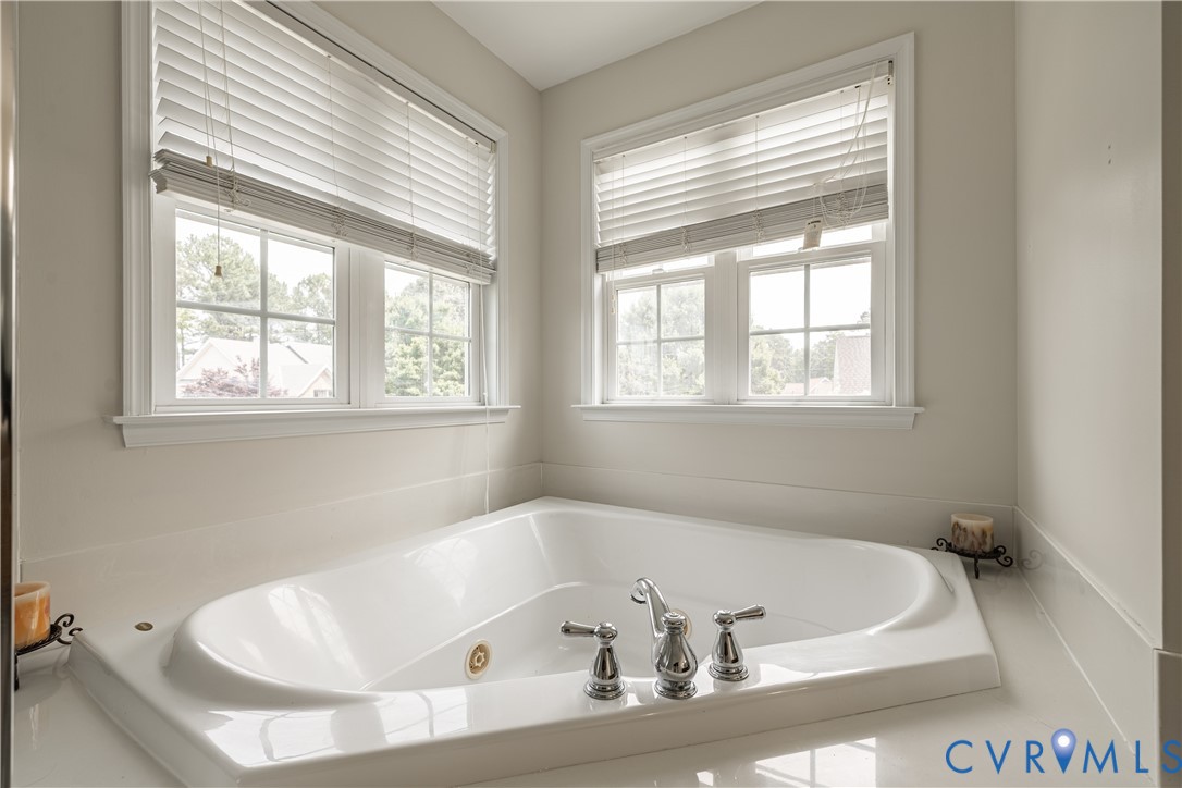 Built-in corner soaking tub featuring chrome fixtures
