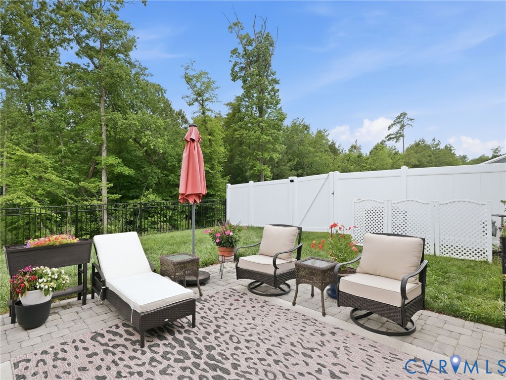 Enjoy the best of both worlds...screened-in comfort & open-air relaxation on this extended paver patio w/a serene wooded view. Black metal fencing added for pet containment yet not to obstruct the gorgeous lush view.