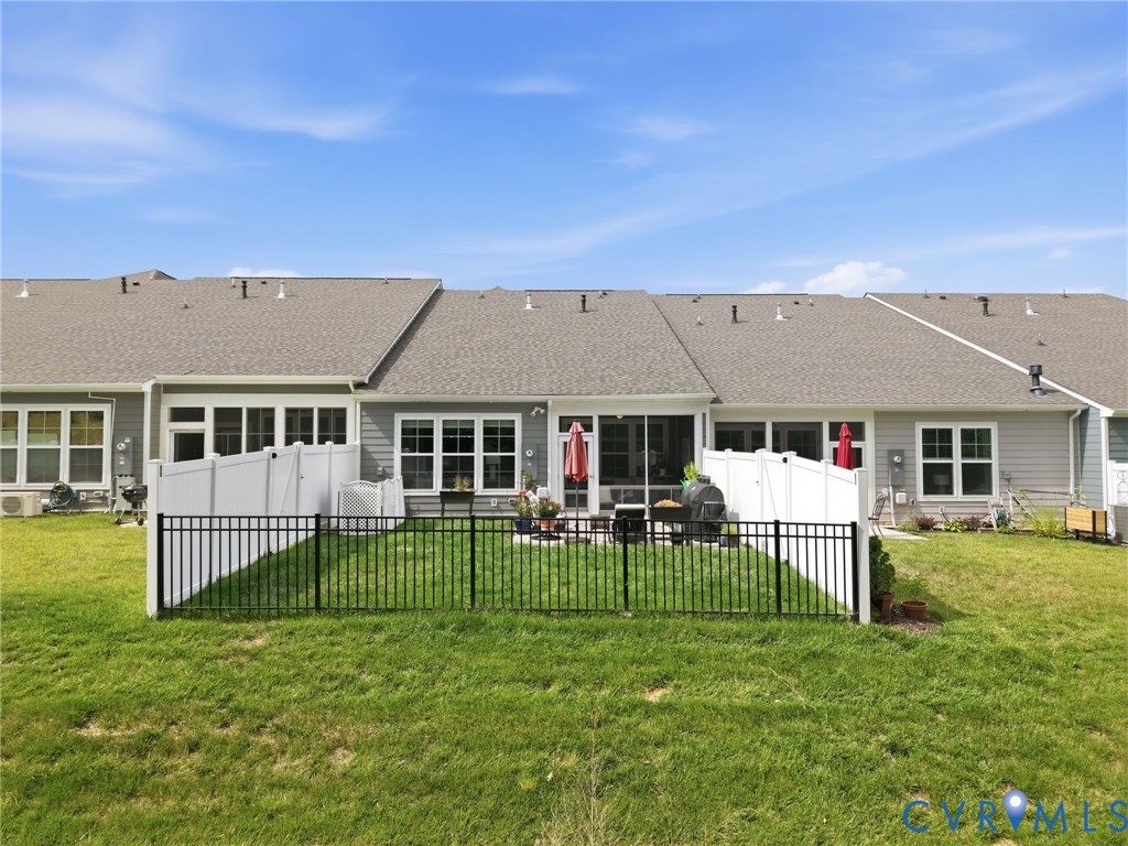 A perfect outdoor setup featuring a screened-in/glassed-in porch, oversized paver patio, and fenced yard, ideal for relaxing or entertaining. Fenced-in area is great for small pets to get some outdoor time or kids to play.