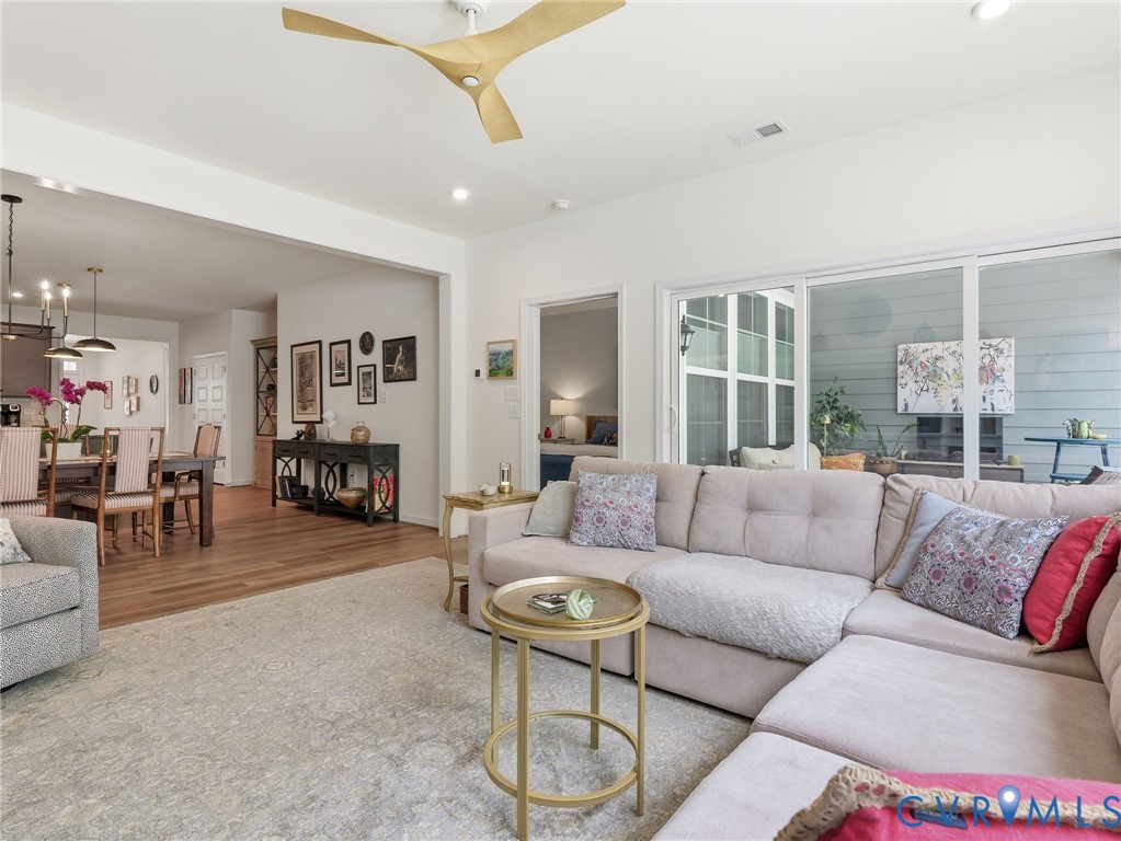 Great room opens directly to a glassed and screened porch. New ceiling fan. Durable hardwood laminate flooring. Great room opens directly to a glassed and screened porch. New ceiling fan. Durable hardwood laminate flooring.