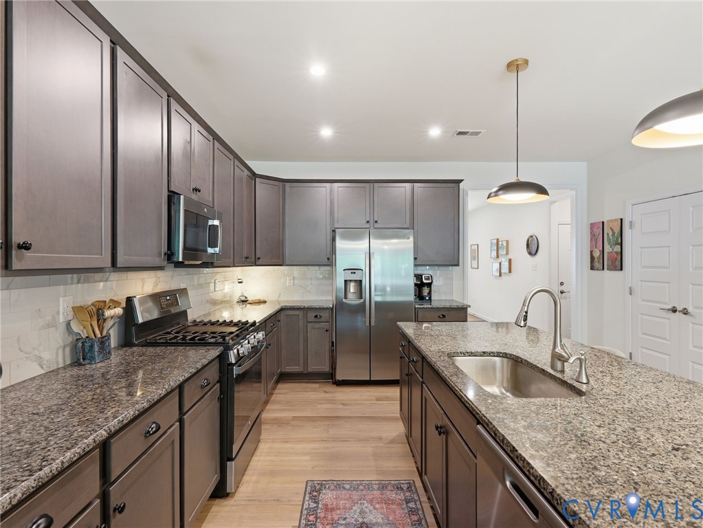 This well designed kitchen comes complete with a spacious pantry, custom contemporary wood cabinetry, and a luxurious island with built-in sink. This well designed kitchen comes complete with a spacious pantry, custom contemporary wood cabinetry, and a luxurious island with built-in sink.
