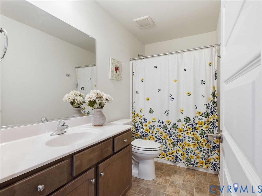 A stylish and practical upstairs hall bath boasting a generous vanity, statement mirror, and full tub/shower combination for ultimate flexibility... perfect for both guests and everyday living.
