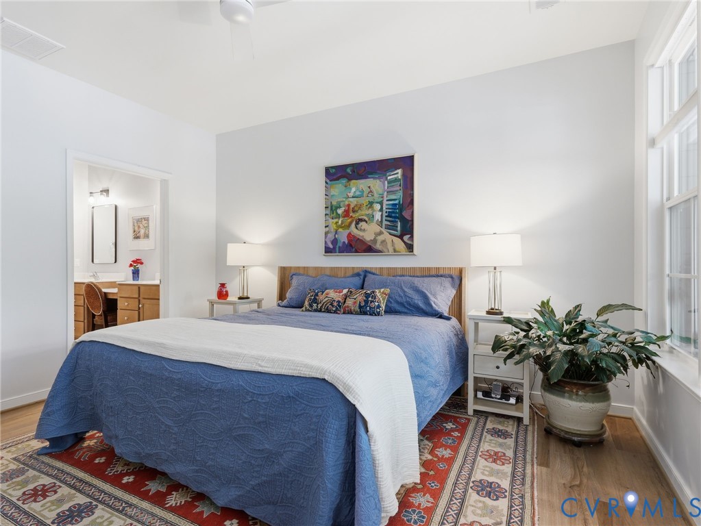 A tranquil primary suite bathed in natural light, featuring refined finishes and a calming, open feel. Your escape from a hectic day.