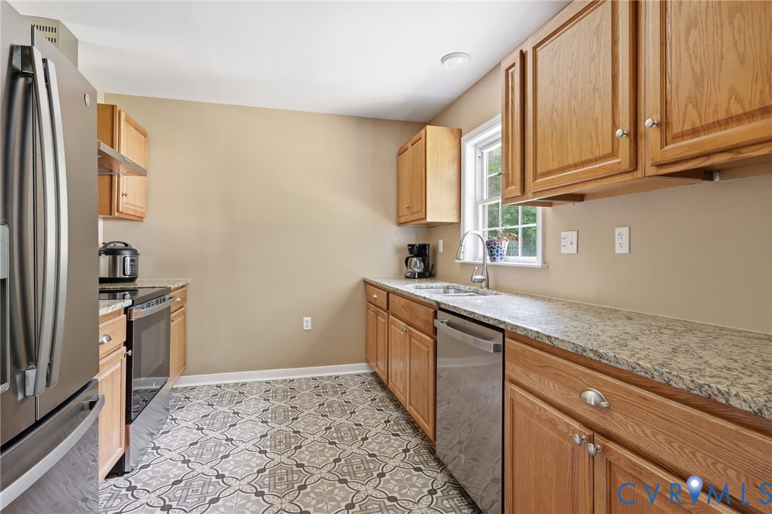 Everything is new in this kitchen: Granite counters, cabinets, ceramic tile flooring appliances!