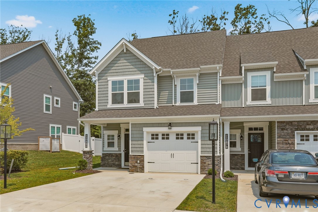 Modern townhome with a two-car driveway and an attached one-car garage