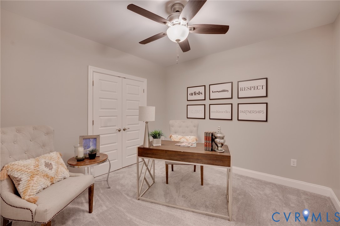 Light gray wall paint complemented by white baseboards, plush gray carpeting, and white paneled double doors