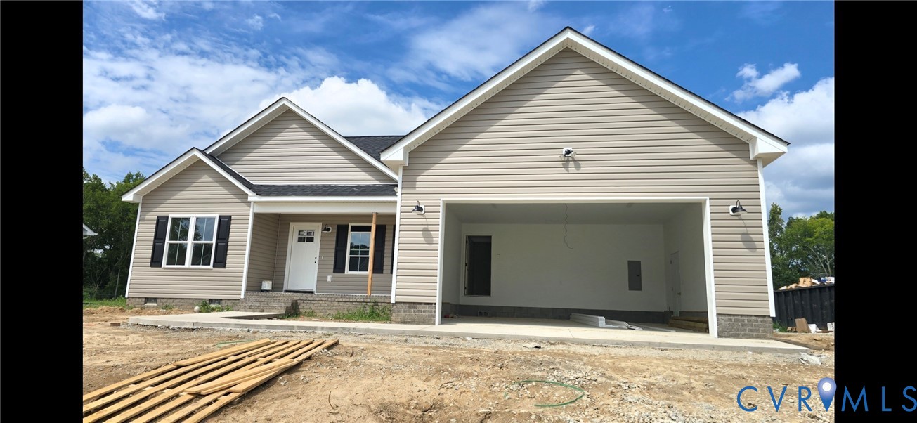 Single-story residence featuring light-colored siding, a covered front porch, and an attached two-car garage