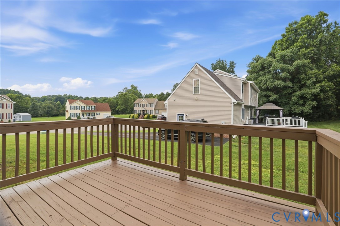 Outdoor deck with wood-finish flooring and matching railings