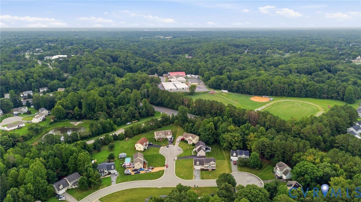 Aerial perspective showcasing a residential area amidst extensive natural landscaping