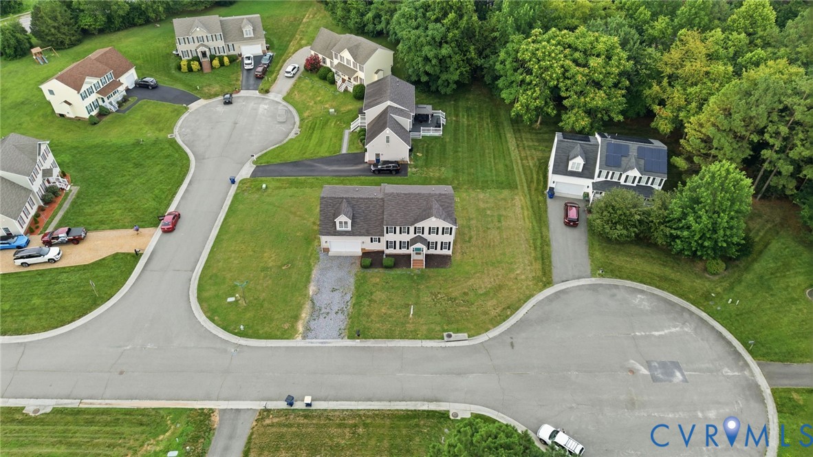 Colonial-style residence featuring a dormer roof, attached garage, and prominent front entry