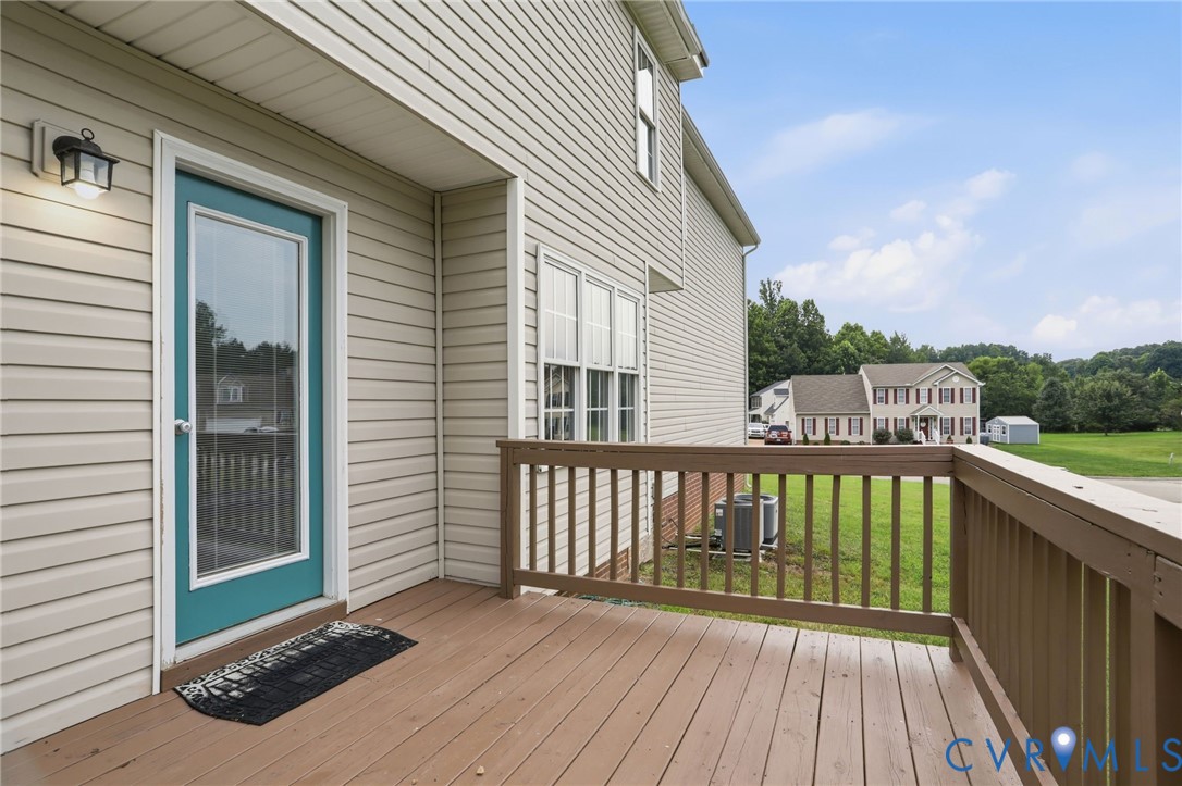 Outdoor deck featuring wood-finish flooring and railing