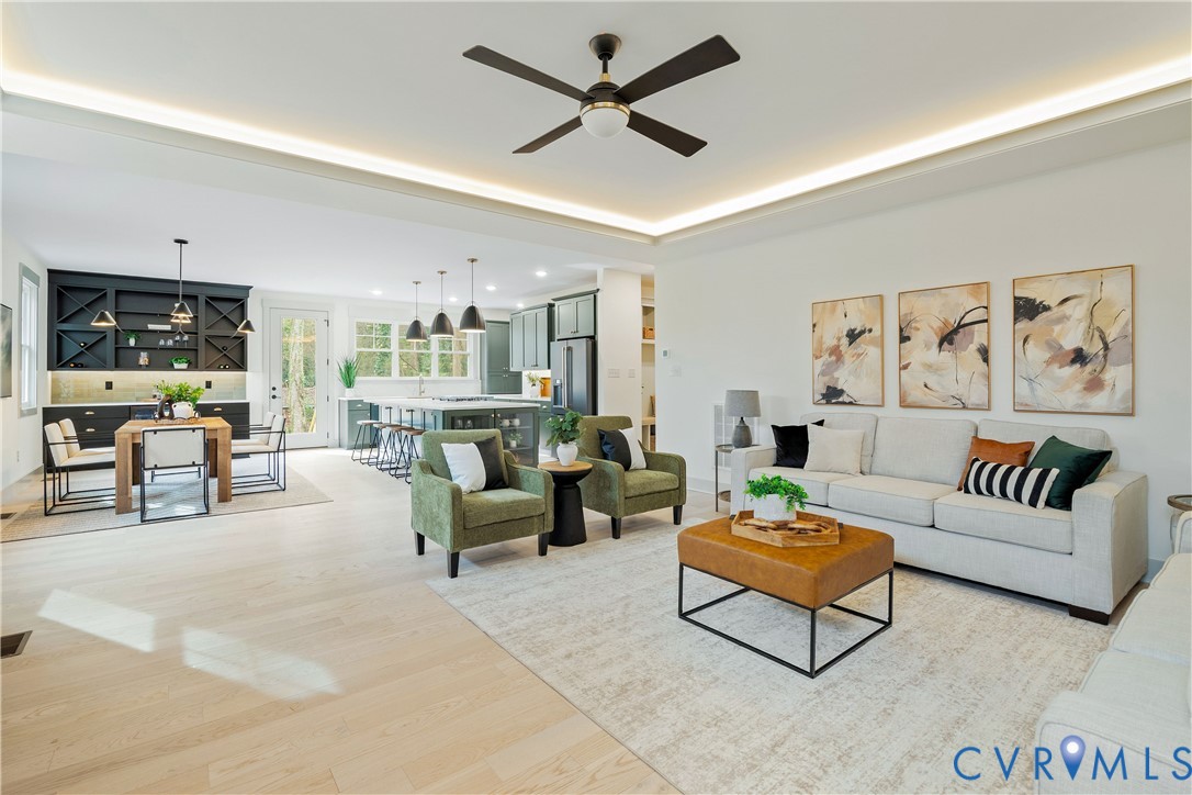 Bright open-concept living area with light wood-finish flooring Bright open-concept living area with light wood-finish flooring