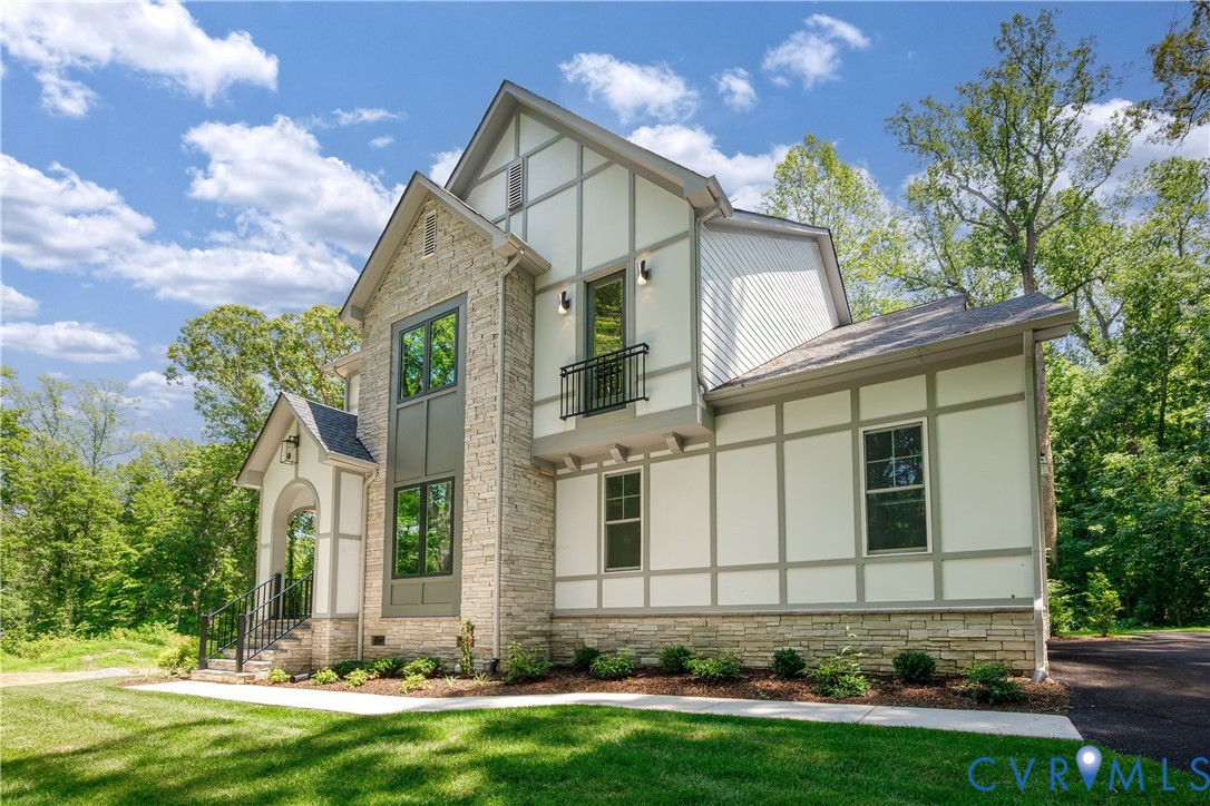 Stone and siding exterior with dark framed windows Stone and siding exterior with dark framed windows