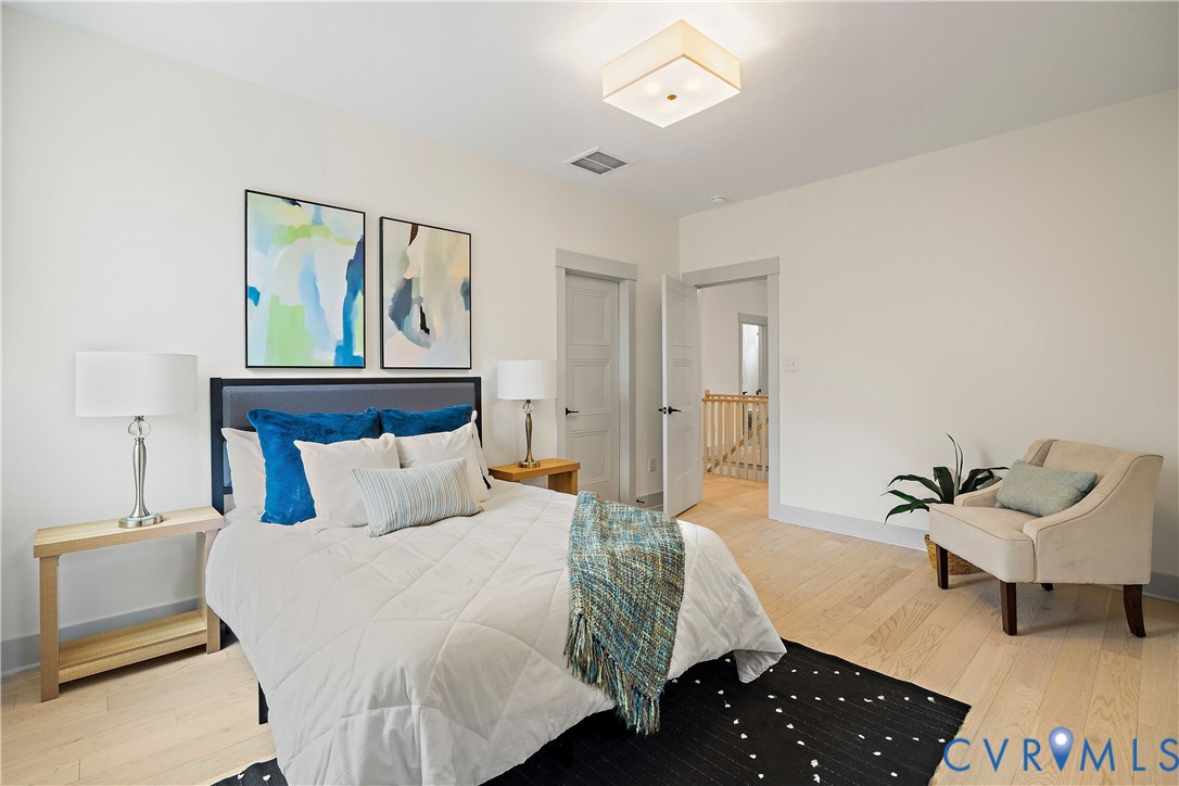 Bedroom 2, 2nd floor featuring light wood-finish flooring, white walls, and a contemporary ceiling light fixture