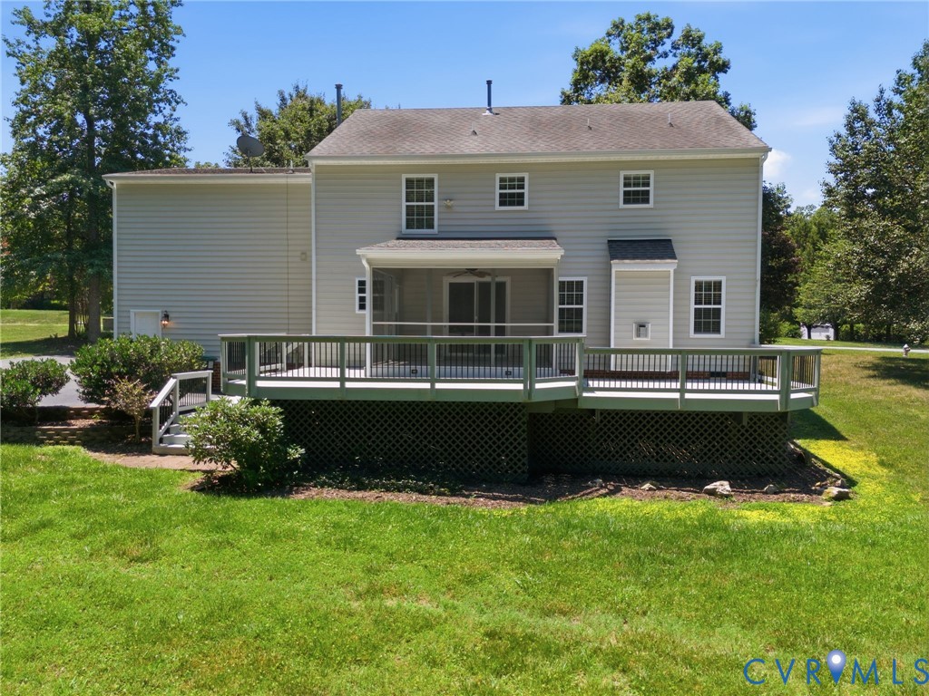 Rear exterior featuring a screened porch, expansive outdoor deck, and a multi-level structure with light-colored siding