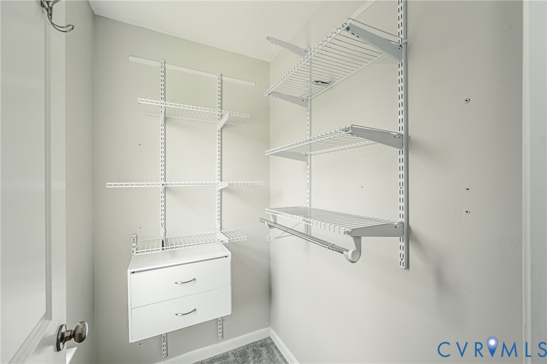 Built-in closet system featuring wire shelving, a hanging rod, and two integrated drawers with chrome hardware