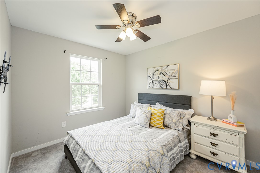 Room featuring neutral wall tones and plush gray carpeting