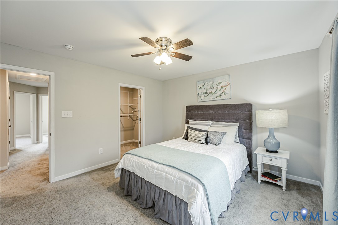 Carpeted interior room featuring light gray walls and white trim