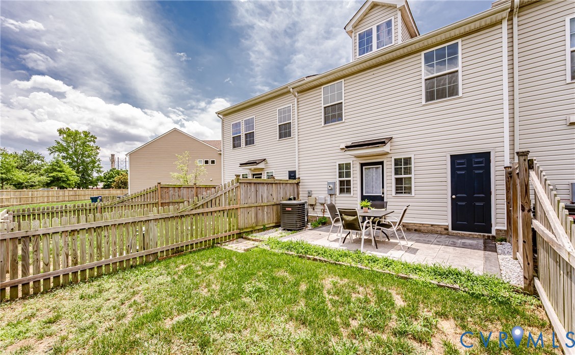 Rear exterior featuring a paver patio and a private fenced yard