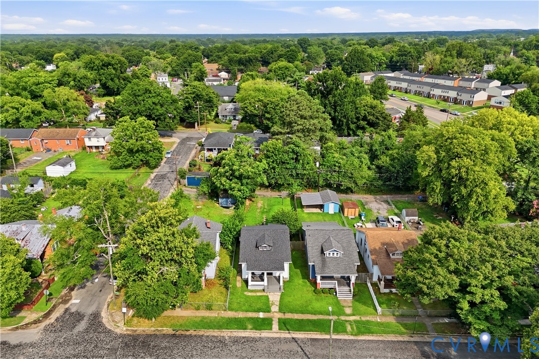 Aerial perspective showcasing a residential neighborhood with a mix of single-family homes and townhouses