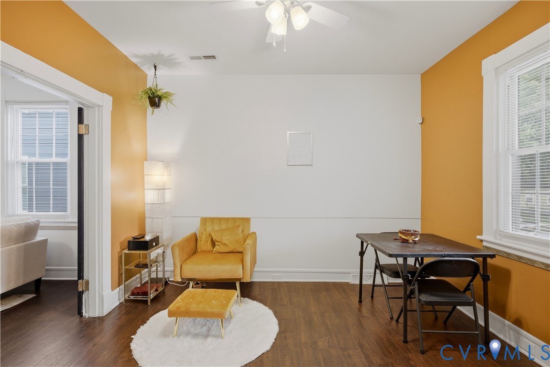 Interior space featuring wood-finish flooring, a ceiling fan with integrated lighting, and a window with blinds Interior space featuring wood-finish flooring, a ceiling fan with integrated lighting, and a window with blinds