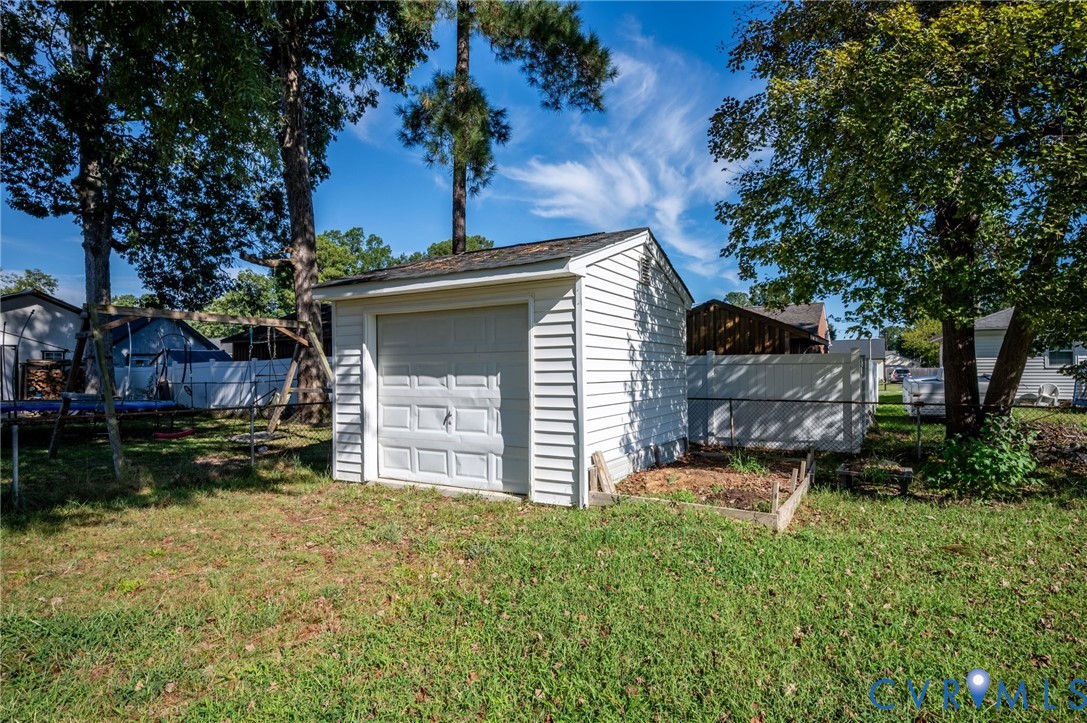 Detached utility shed with a roll-up garage door