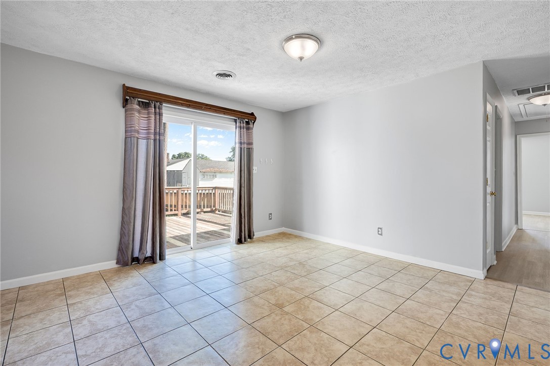 Ceramic tile flooring, sliding glass door, and exterior wood deck
