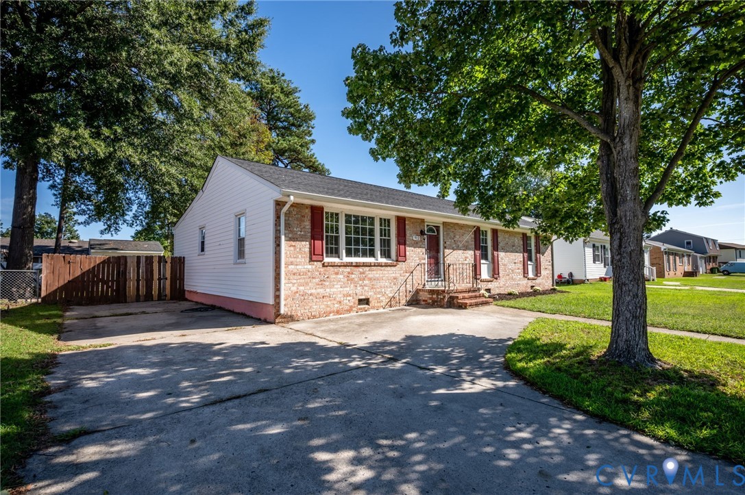 Brick and siding exterior with red shutters