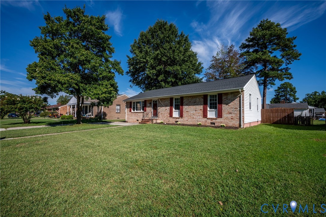 Brick and siding exterior with a dark shingle roof