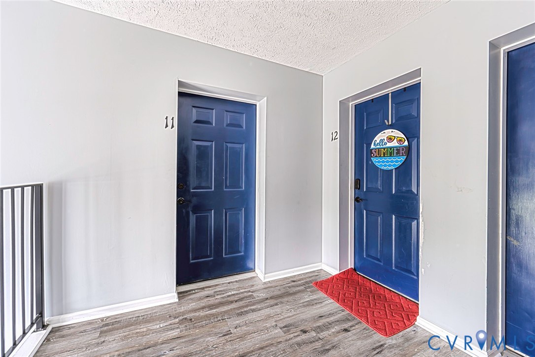 Entry corridor featuring wood-finish flooring and light gray walls