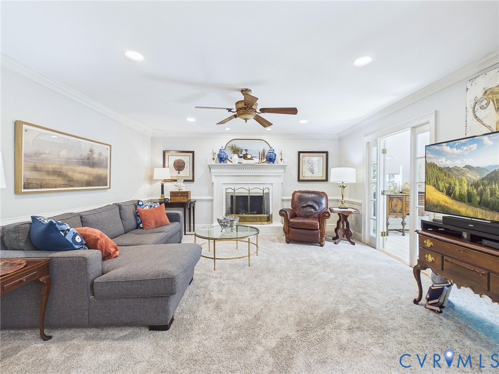 Living space featuring light-colored carpeting and recessed lighting