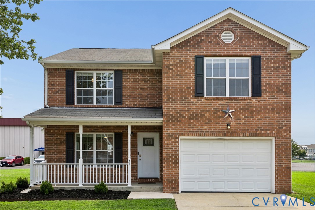 Brick two-story facade with an attached single-car garage and a covered front porch featuring white railing Brick two-story facade with an attached single-car garage and a covered front porch featuring white railing