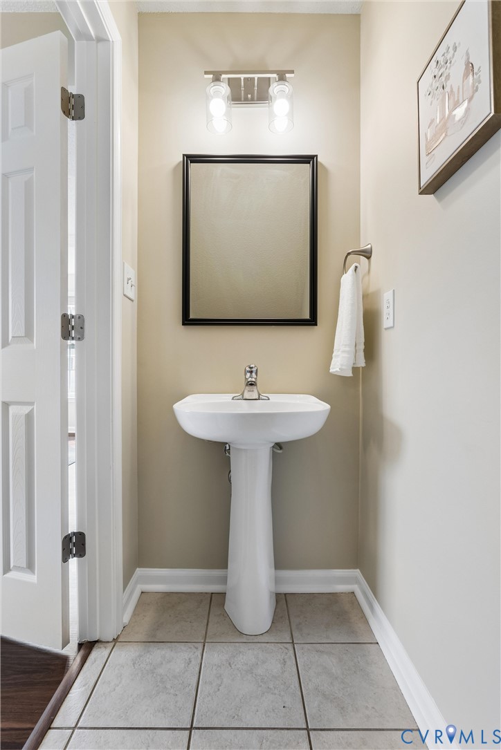 Pedestal sink with chrome faucet and square framed mirror