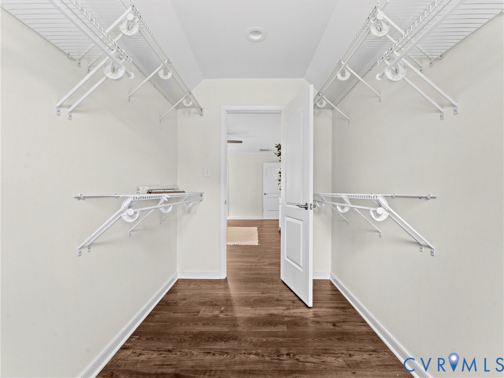 Walk-in closet featuring wood-finish flooring, white wire shelving, and recessed lighting