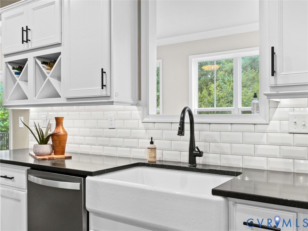 White farmhouse sink with a matte black gooseneck faucet