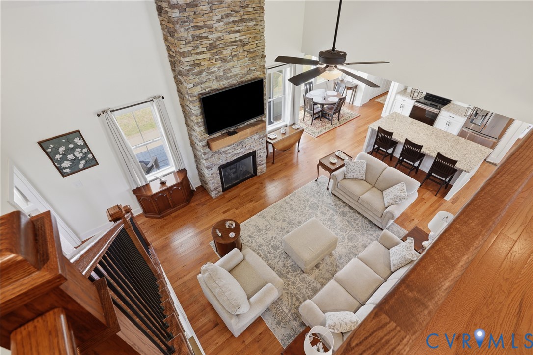 Open-concept living area featuring a vaulted ceiling and wood-finish flooring