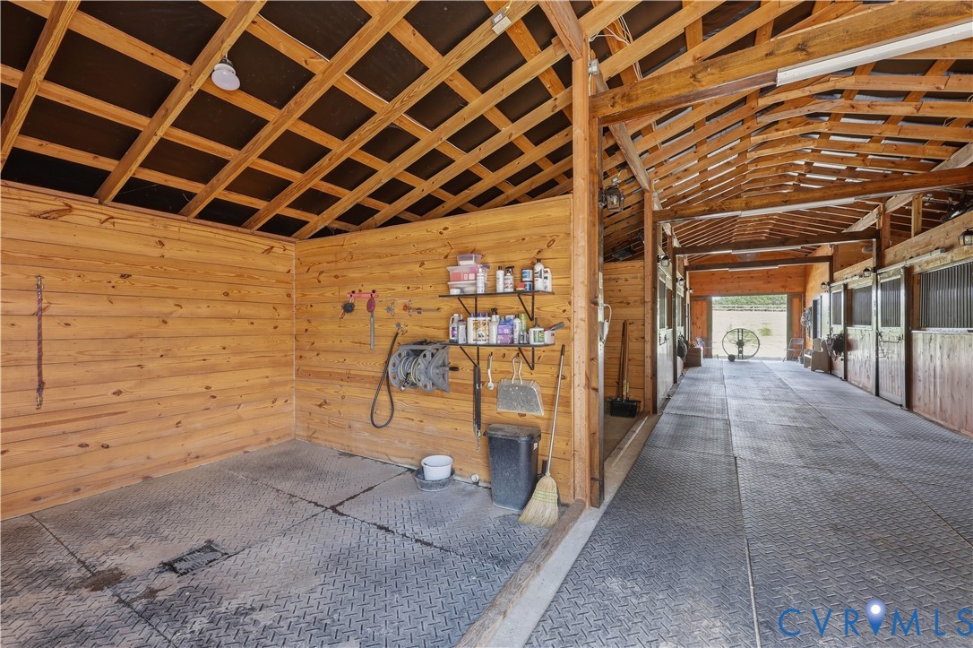 Barn interior featuring wood plank walls and exposed wood beam ceiling