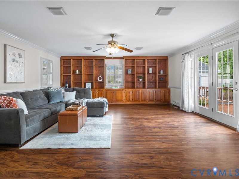 Massive rear Family Room with built-in bookshelves, wood laminate flooring and French doors to the rear deck.
