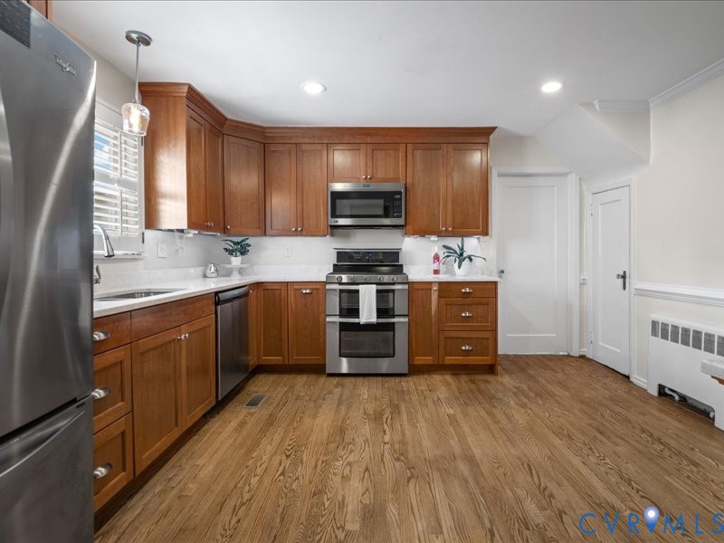 Remodeled- Warm Cherry cabinets, quartz countertops and stainless appliances.