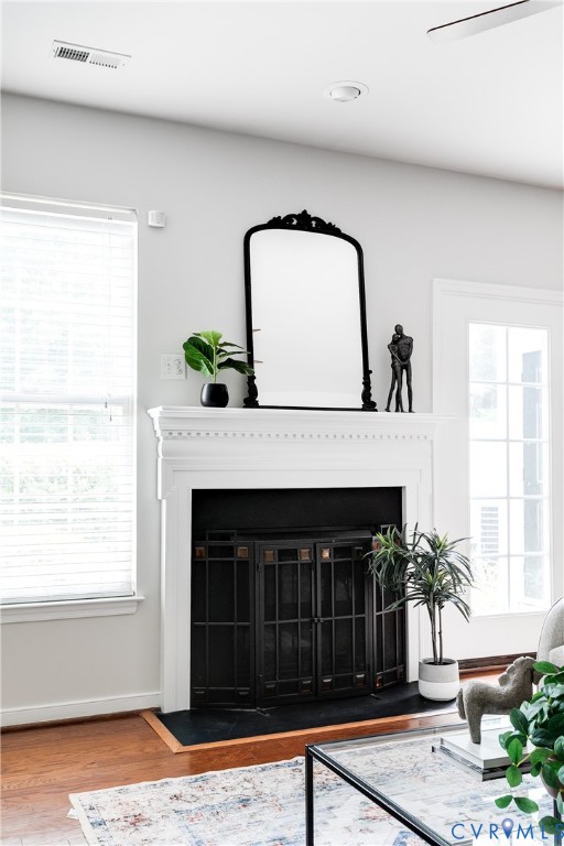 Fireplace featuring a classic white mantel, black fire screen, and dark hearth