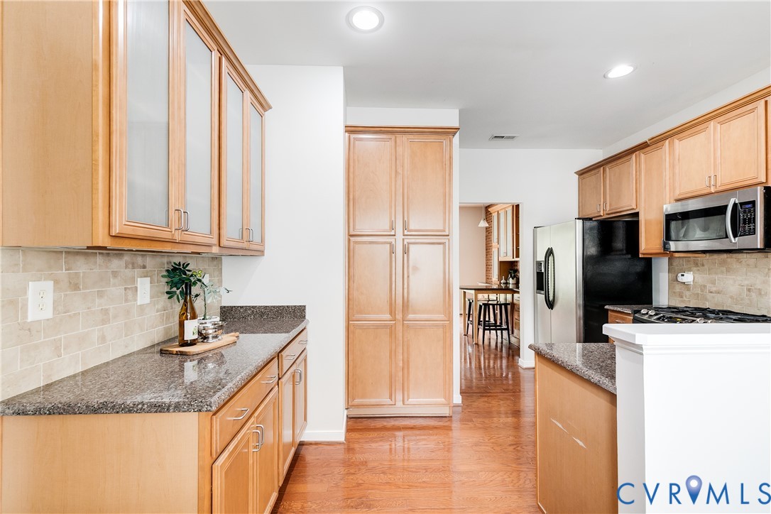 Kitchen featuring wood-finish flooring, recessed lighting, and light wood cabinetry