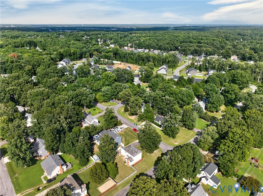Expansive green landscape with mature trees and residential homes