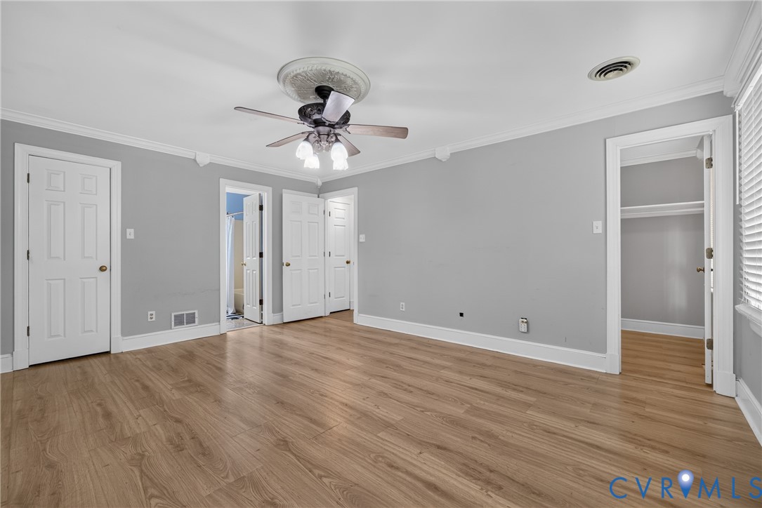 Wood-finish flooring with light gray walls and white trim