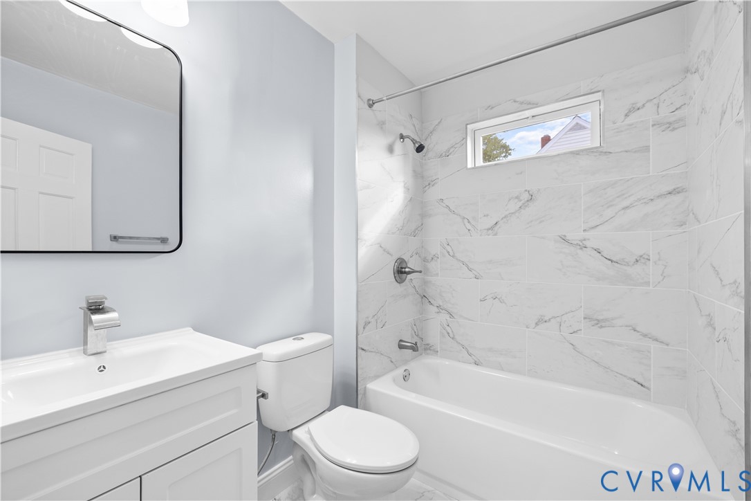 White vanity with integrated sink and chrome faucet White vanity with integrated sink and chrome faucet