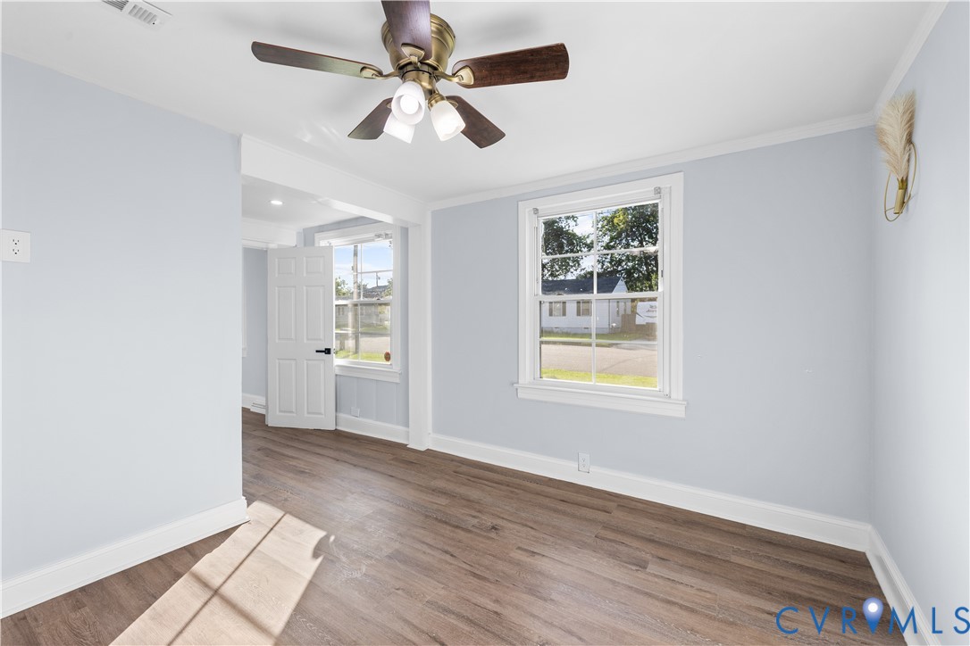 Wood-finish flooring, light blue wall paint, and white trim