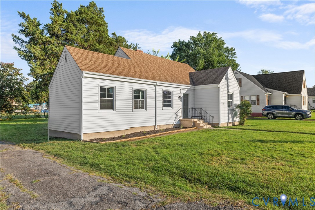 Single-story dwelling with white siding and a brown shingle roof