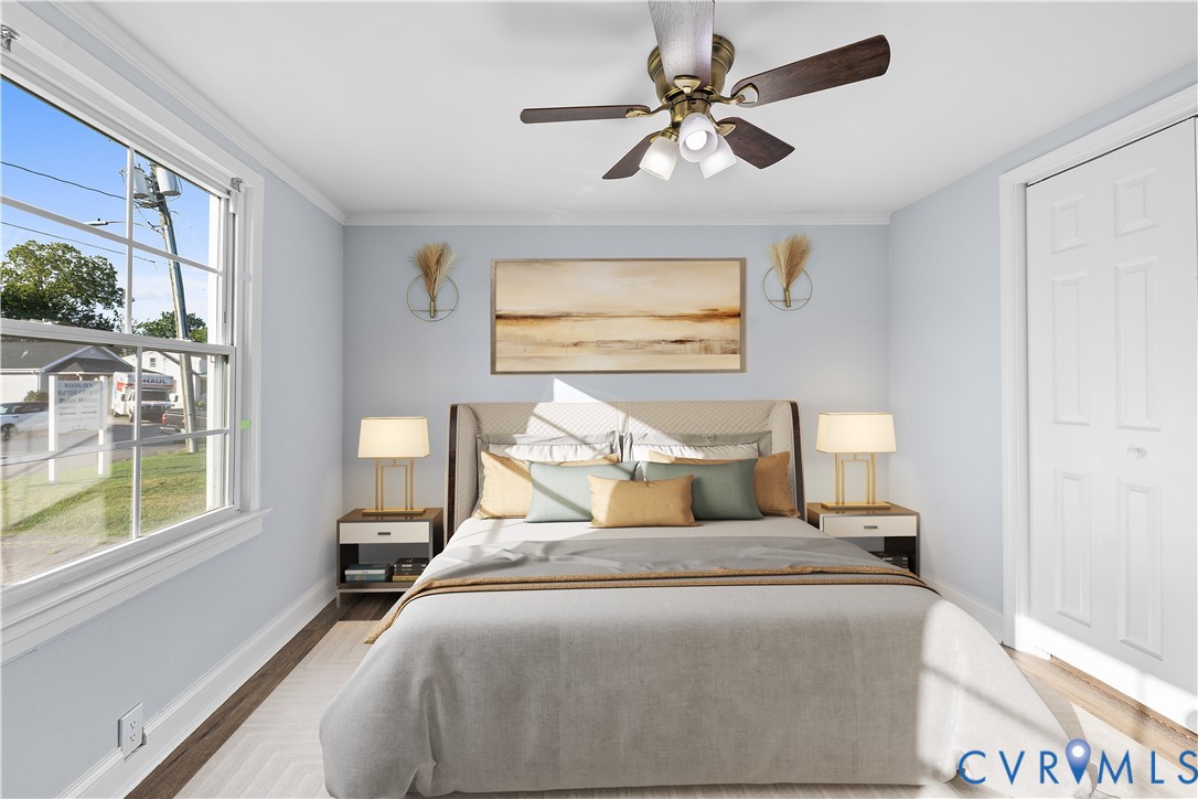 (Virtually-Staged) Ceiling-mounted fan with integrated lighting, wood-finish flooring, and a window with white sashes