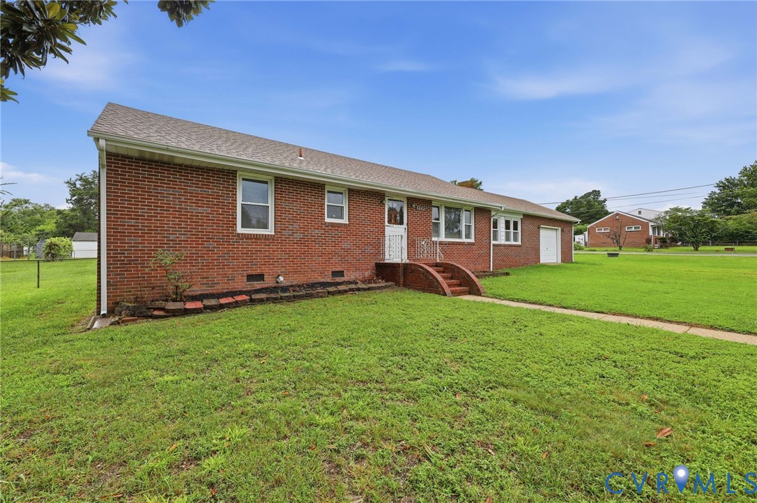 Brick exterior with a gabled roof and white window frames