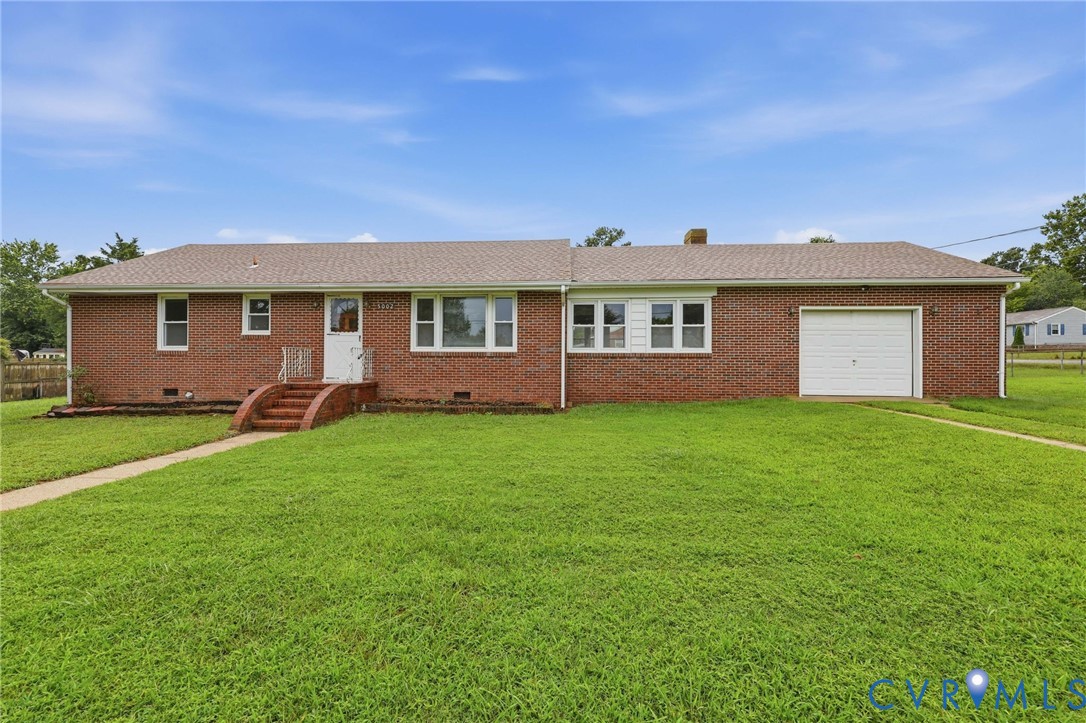 Brick exterior with a gabled roof and attached garage