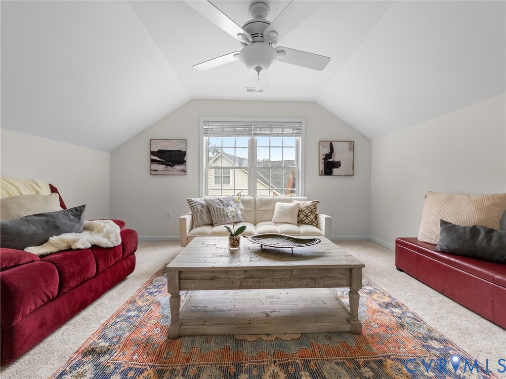 Sloped ceilings, overhead ceiling fan, carpeted flooring, and a window with horizontal blinds